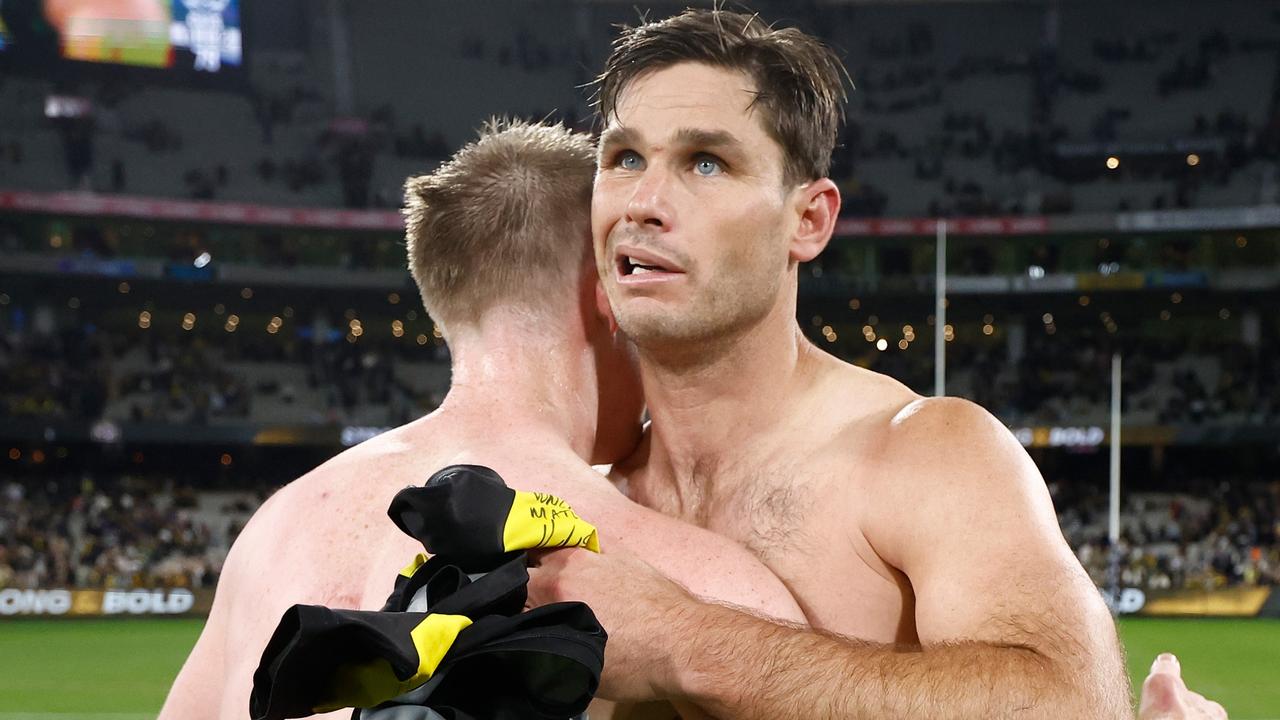 Hawkins and Riewoldt embrace.