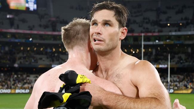 Hawkins and Riewoldt embrace.
