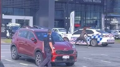 A man armed with a pole and machete has smashed the window of a car before driving off in a stolen patrol car. Picture: Supplied