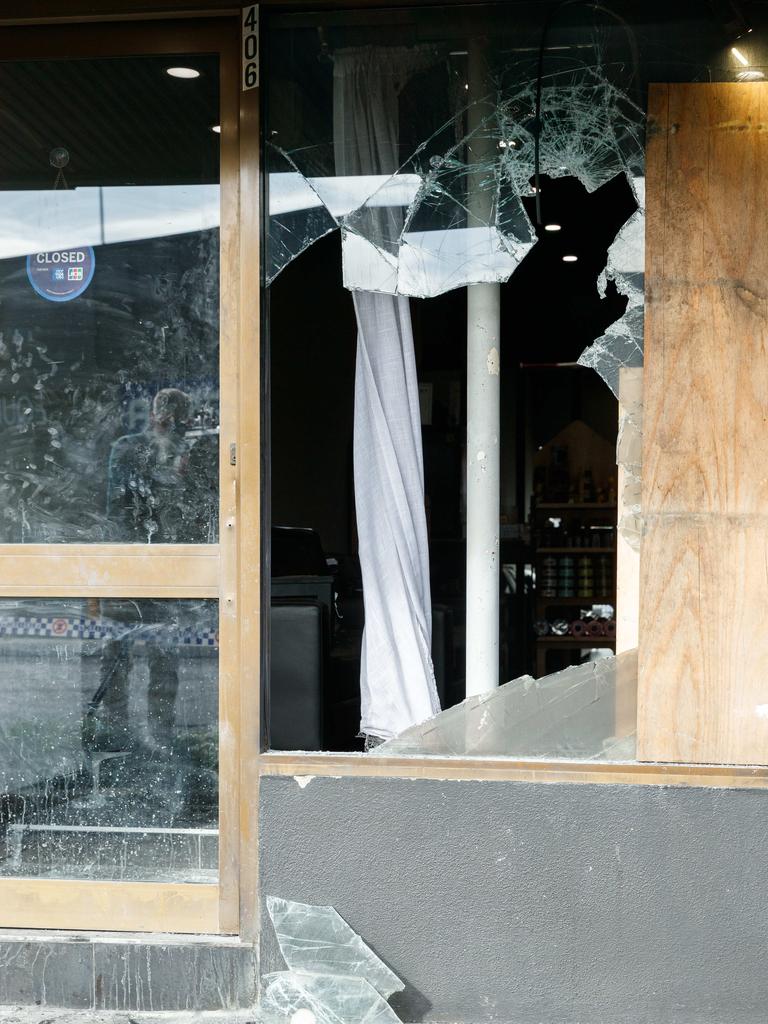 The barber shop window was smashed. Picture: NewsWire / Max Mason-Hubers