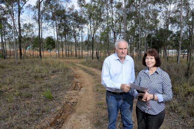 John and Kathryn Mahoney are disputing the government change made to their land in Deebing Heights. It has been changed from development purpose land to rural (with a lower value) despite development occurring on the property opposite (as seen behind). Picture: Rob Williams