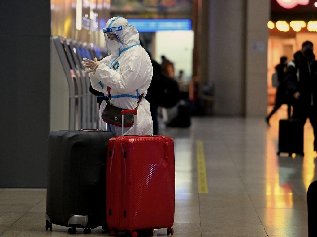 A passenger wears personal protective equipment at a train station in Beijing. Picture: Noel Celis/AFP