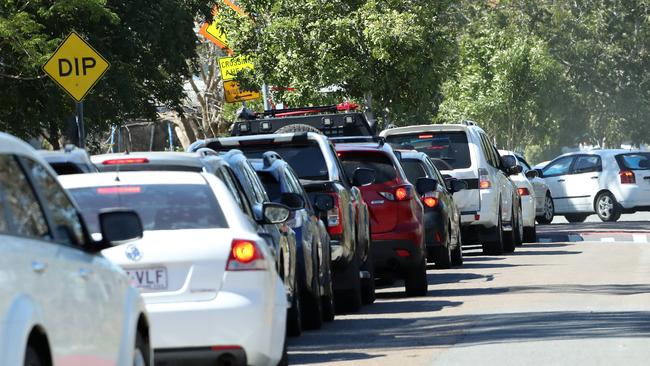 Cars lined up on Goburra Street outside the COVID testing centre at Rocklea Showgrounds. Picture: Liam Kidston