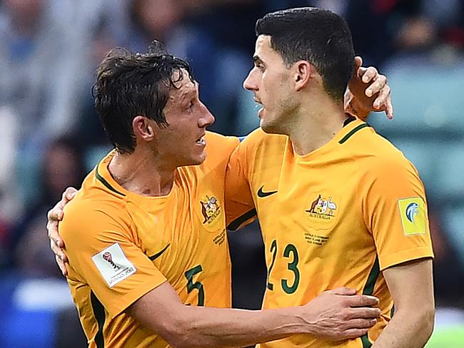 Australia's forward Tommy Rogic (R) is congratulated by midfielder Mark Milligan after scoring a goal during the 2017 Confederations Cup group B football match between Australia and Germany at the Fisht Stadium in Sochi on June 19, 2017. / AFP PHOTO / FRANCK FIFE