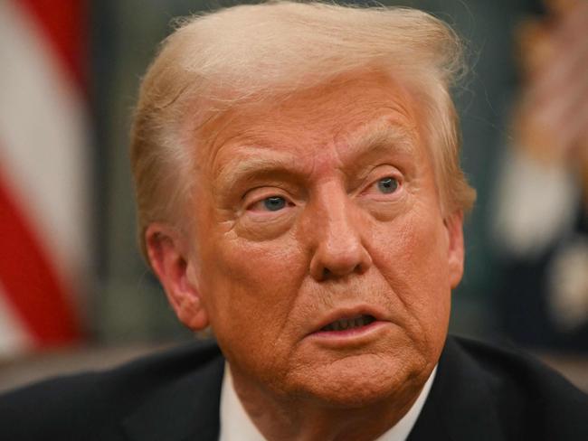 US President Donald Trump speaks to journalists as he signs executive orders in the Oval Office of the WHite House in Washington, DC, on January 20, 2025. (Photo by Jim WATSON / POOL / AFP)