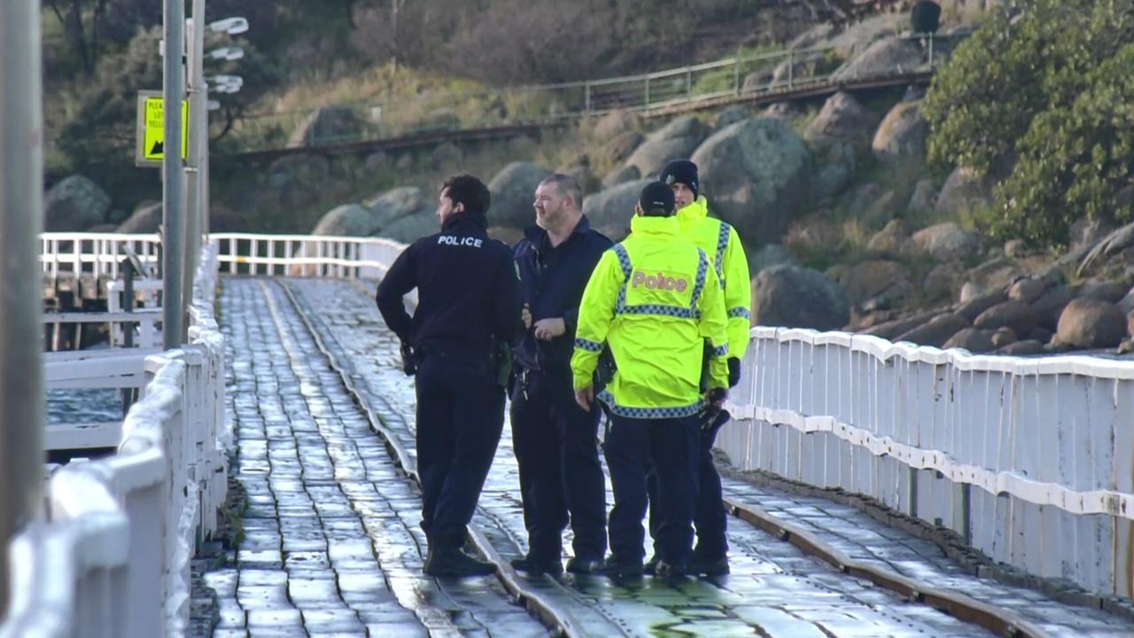 Police on the Granite Island causeway on Tuesday as rescuers and volunteers started searching around the island for Mr Higgins. Picture: Gary Juleff