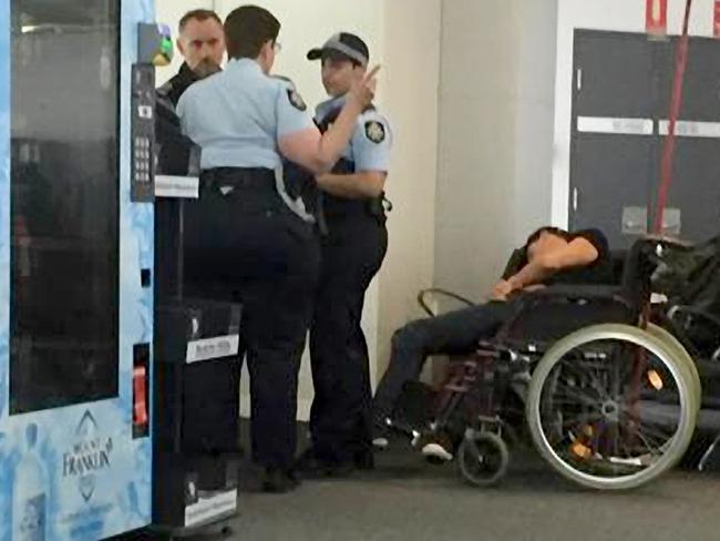 Grant Hackett slumps in a wheelchair after being removed from a flight from Adelaide to Melbourne following an altercation with a fellow passenger. Picture: Seven News