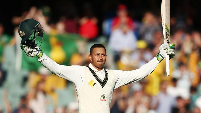 Usman Khawaja celebrates reaching his ton.