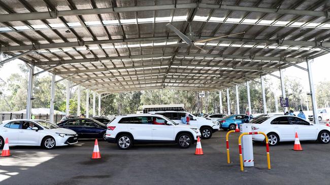 People queue up at the Fairfield Showground Sypath Drive-through Covid-19 clinic to be tested on Monday. Picture: NCA NewsWire / Christian Gilles