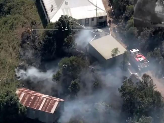 Three mile fire: Fire crews work to save a property at Wiseman's Ferry threatened by the Three mile bushfire.