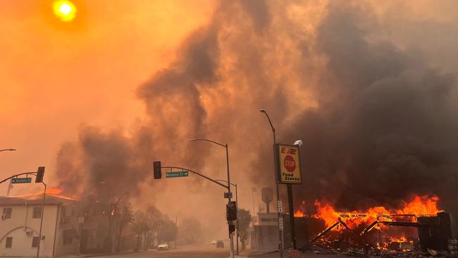 Flames from the wind-driven Eaton Fire engulf a house in Altadena. Picture: AFP