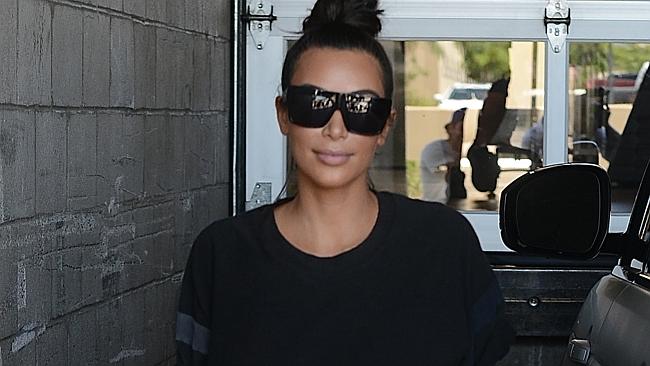 Kim Kardashian spills out of tight black corset as she steps off