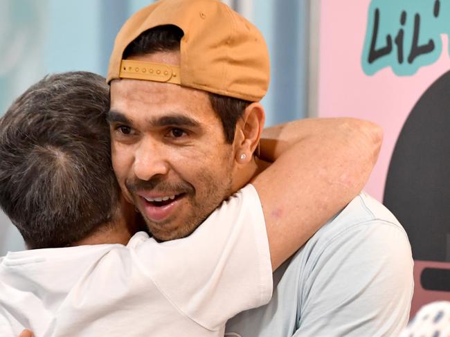 Adelaide Crows football star Eddie Betts hugs a fan during his book signing at the Royal Adelaide Show in Adelaide, Friday, August 30, 2019. (AAP Image/Sam Wundke) NO ARCHIVING