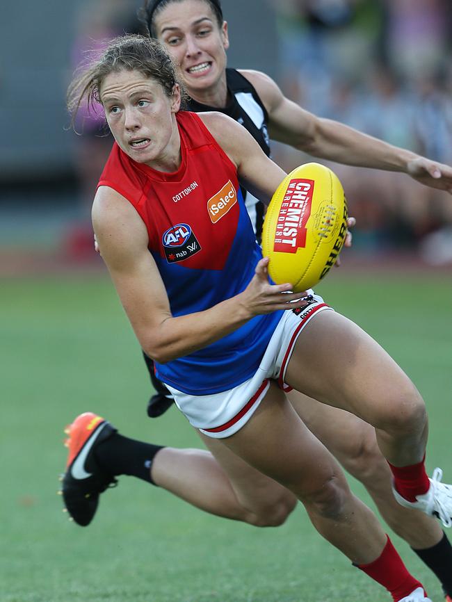 Ashleigh Guest is chased by Collingwood’s Ash Brazill. Picture: Ian Currie