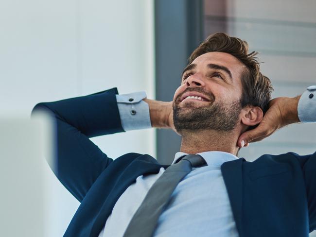 Shot of a young corporate businessman taking a break at an office desk