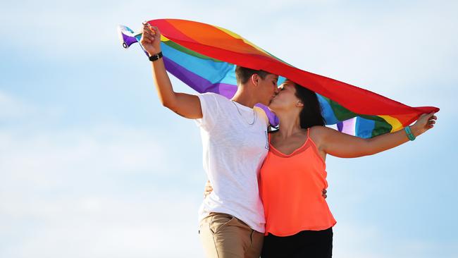 Carly and Christie had a commitment ceremony on the beaches and will get married legally when law changes. Picture: Braden Fastier