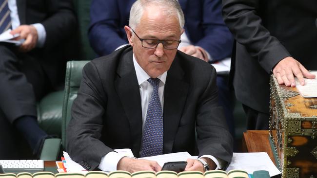 Malcolm Turnbull checks his phone as he waits on news from the High Court. Picture: Kym Smith