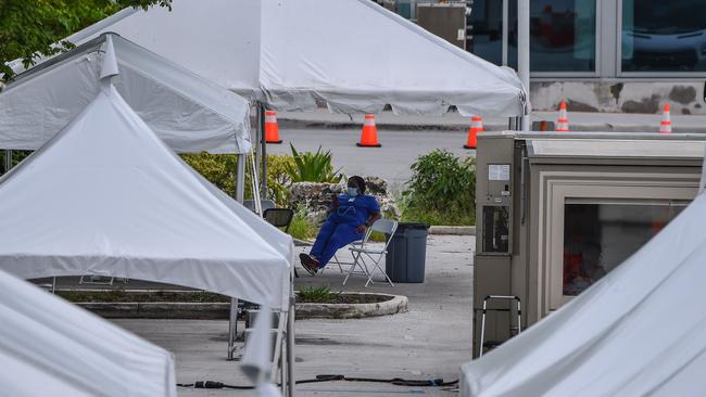 A medical staff member takes a break at a walk-in and drive-through coronavirus testing site in Miami Beach. Picture: AFP.