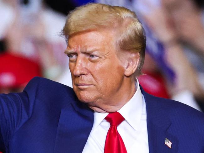 TOPSHOT - Former US President and Republican presidential candidate Donald Trump leaves the stage after a campaign rally at the Bryce Jordan Center in State College, Pennsylvania, October 26, 2024. (Photo by Charly TRIBALLEAU / AFP)