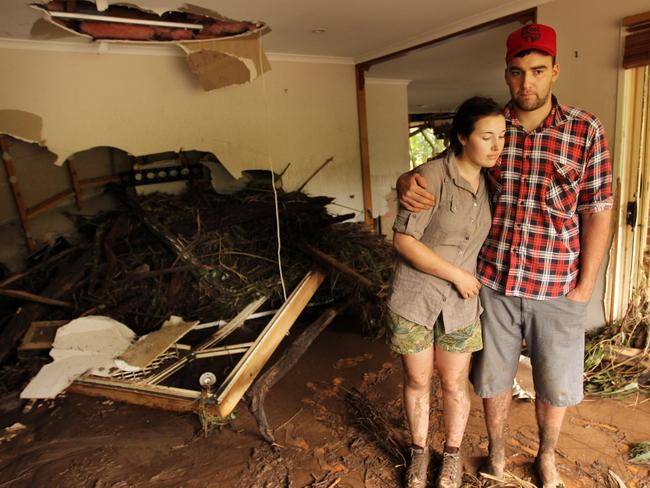 Victoria and Sam Matthews inspect their flood-damaged Spring Bluff home in January 2011. Picture: Lyndon Mechielsen