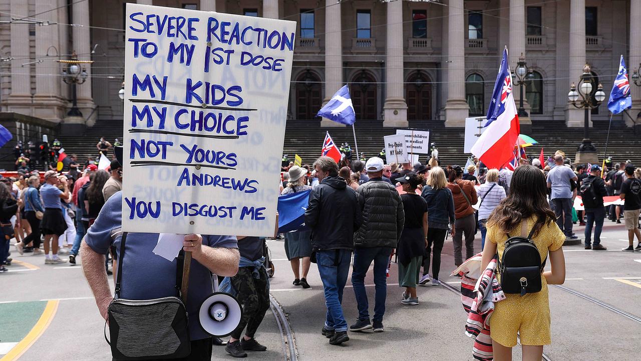 Protesters made signs to let Daniel Andrews know their opinions on vaccine mandates. Picture: NCA NewsWire / Ian Currie