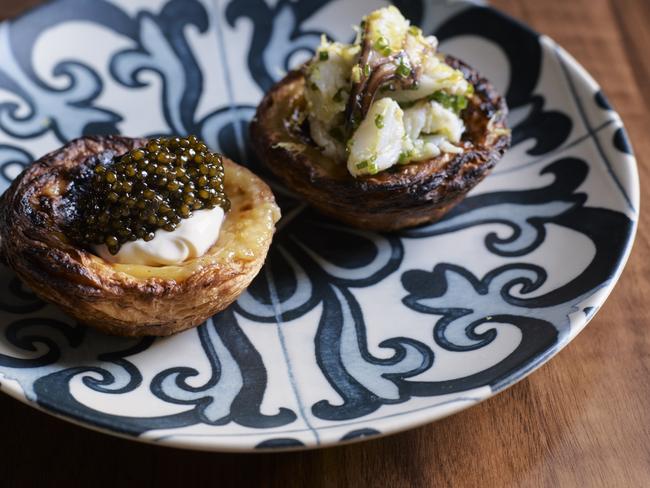 Blue swimmer crab egg tart (right) and cauliflower egg tart with caviar. Picture: Anson Smart