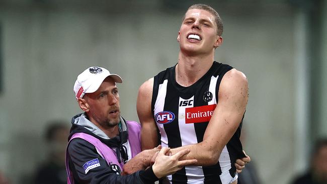 The young Pies gun is helped from the field.