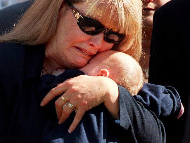 Carmel Arthur comforting her son Jimmy at the 1998 funeral of her murdered husband, Senior-Constable Rod Miller.