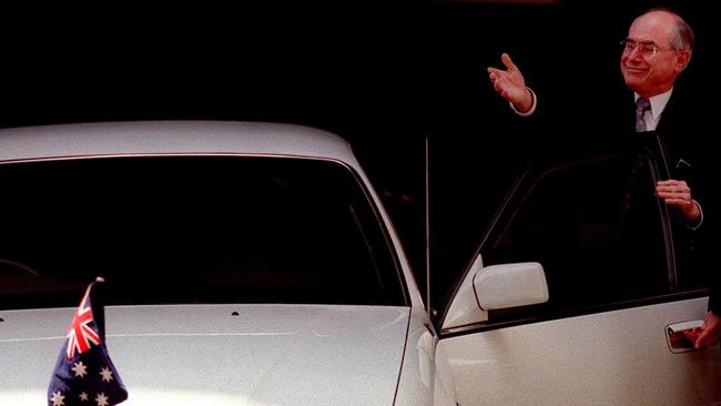 John Howard admires the Australian flag on the hood of his Commonwealth car the morning after the republic referendum.