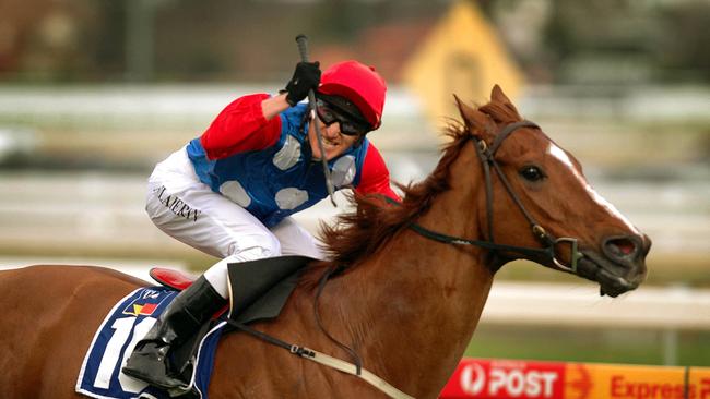 Jockey Mark Flaherty salutes as Regal Roller wins the 2004 JJ Liston Stakes. Picture: Andrew Maccoll