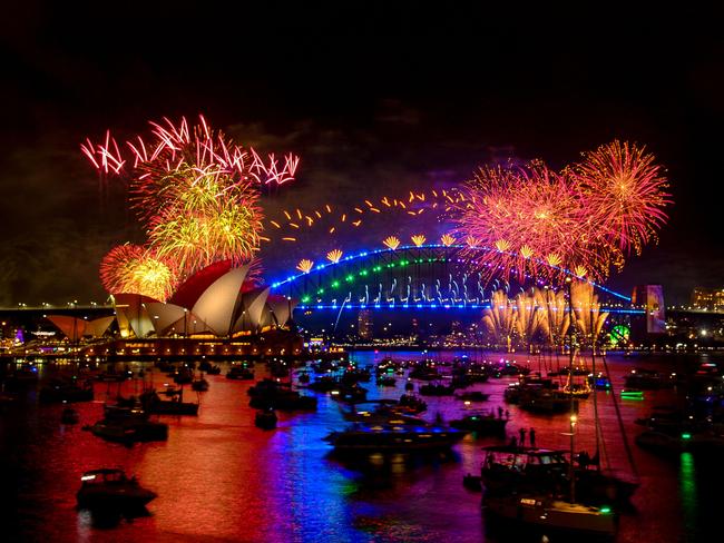 TOPSHOT - Fireworks explode over the Sydney Harbour Bridge and Sydney Opera House (L) during New Year's Eve celebrations in Sydney on January 1, 2024. (Photo by Izhar KHAN / AFP)