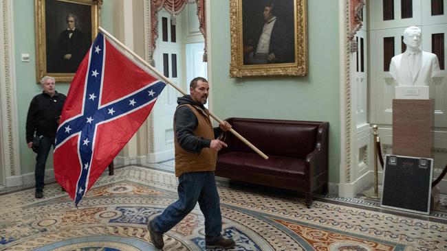 A rioter carries a Confederate flag in the US Capitol on January 6 last year. Picture: AFP