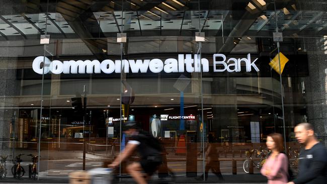 People walk by a Commonwealth Bank branch in Brisbane. (AAP Image/Dan Peled)