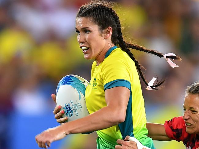 GOLD COAST, AUSTRALIA - APRIL 13:  Charlotte Caslick of Australia is tackled by Jasmine Joyce of Wales during the Rugby Sevens Women's Pool B match between Australia and Wales on day nine of the Gold Coast 2018 Commonwealth Games at Robina Stadium on April 13, 2018 on the Gold Coast, Australia. (Photo by Dan Mullan/Getty Images)