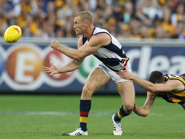 Scott Thompson handballs gives his all in the preliminary final loss to Hawthorn.